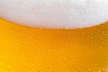 Light beer in a glass on a table in composition with accessories on an old background