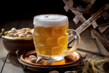 Light beer in a glass, on an old background.