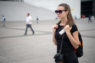 Tourist used to use paper sheet map. Backpacker use paper map for navigation. Girl tourist...