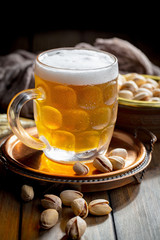 Light beer in a glass, on an old background. 