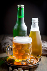 Light beer in a glass, on an old background. 