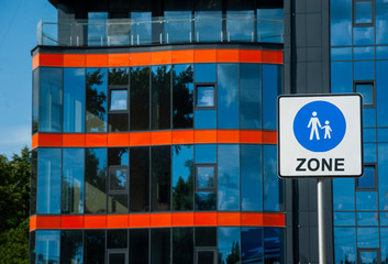 pedestrian zone sign on the background of modern street