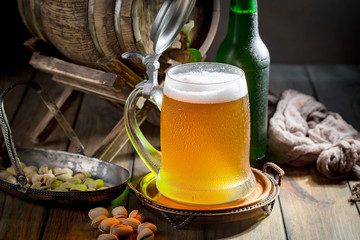 Light beer in a glass, on an old background. 