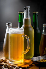 Light frothing beer in a glass, on an old background.