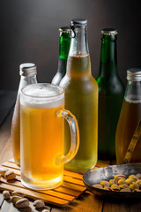 Light beer in a glass on a table in composition with accessories on an old background