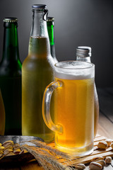 Light beer in a glass on a table in composition with accessories on an old background