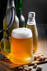 Light beer in a glass on a table in composition with accessories on an old background