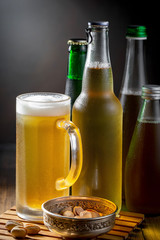 Light beer in a glass on a table in composition with accessories on an old background
