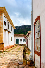 Paving stones made by slaves on the streets with colonial-style houses in the city of Tiradentes city, Minas Gerais state, built in the 18th century