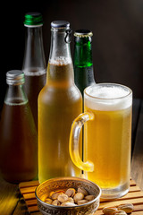 Light beer in a glass on a table in composition with accessories on an old background