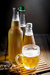 Light beer in a glass on a table in composition with accessories on an old background