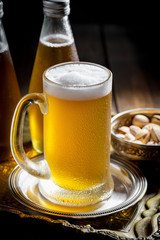 Light beer in a glass, on an old background.