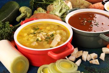 Set of soups from worldwide cuisines, healthy food. Broth with noodles, beef soup and broth with marrow dumplings. All soups with healthy vegetables on table