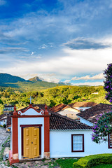 Stone streets of the old and historic city of Tiradentes, with its colonial architecture houses, a small 18th century church and the mountain and forest in the background