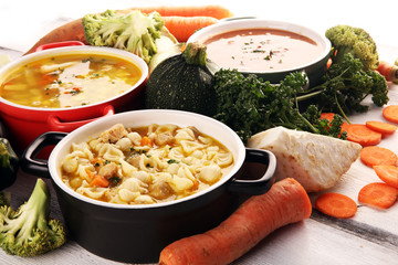 Set of soups from worldwide cuisines, healthy food. Broth with noodles, beef soup and broth with marrow dumplings. All soups with healthy vegetables on table