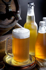Light beer in a glass on a table in composition with accessories on an old background