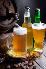 Light beer in a glass on a table in composition with accessories on an old background