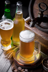 Light beer in a glass on a table in composition with accessories on an old background