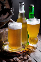 Light beer in a glass on a table in composition with accessories on an old background