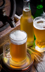 Light beer in a glass on a table in composition with accessories on an old background
