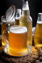 Light beer in a glass on a table in composition with accessories on an old background