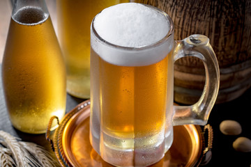 Light beer in a glass, on an old background.