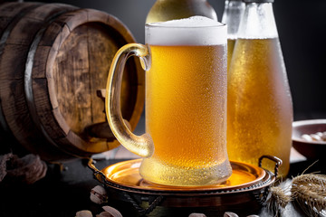 Light beer in a glass on a table in composition with accessories on an old background