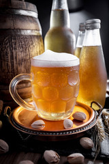 Light beer in a glass, on an old background.