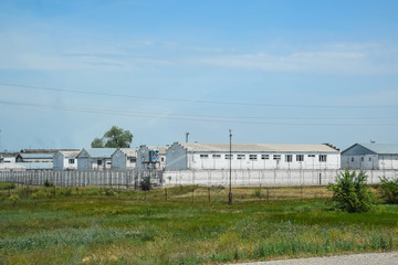 building and the fence of the prison. Prison Correctional Facility.