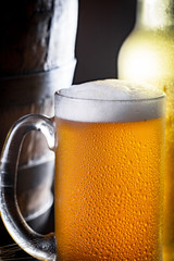 Light beer in a glass on a table in composition with accessories on an old background