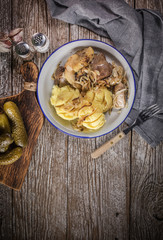 Fried liver with onion and apple, served with boiled potatoes and pickled cucumber.