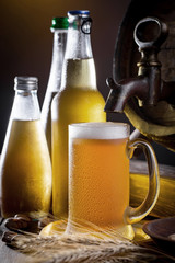 Light beer in a glass on a table in composition with accessories on an old background