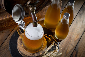 Light beer in a glass on a table in composition with accessories on an old background