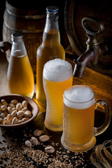Light beer in a glass, on an old background.