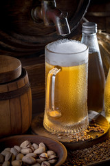 Light beer in a glass on a table in composition with accessories on an old background