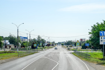 Asphalt road on which cars go. Landscape view from cab
