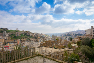 Fototapeta na wymiar Cityscape of downtown Amman in Jordan on a sunny day with hills in the background