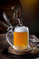 Light beer in a glass on a table in composition with accessories on an old background