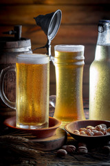 Light beer in a glass on a table in composition with accessories on an old background