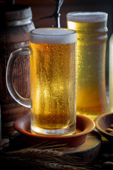 Light beer in a glass on a table in composition with accessories on an old background