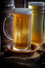 Light beer in a glass on a table in composition with accessories on an old background