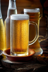 Light beer in a glass, on an old background.