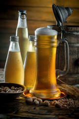 Light beer in a glass on a table in composition with accessories on an old background