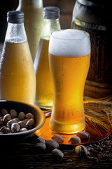 Light beer in a glass on a table in composition with accessories on an old background
