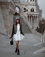 Fototapeta na wymiar Fashion portrait photo of young woman with stylish outfit in Budapest