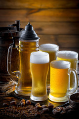 Light beer in a glass on a table in composition with accessories on an old background