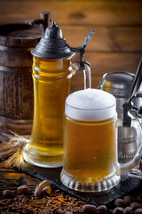Light beer in a glass on a table in composition with accessories on an old background
