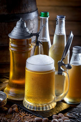 Light frothing beer in a glass, on an old background.