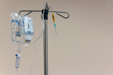 A stand with a dropper and therapeutic solutions prepared for intravenous infusion of drugs. Place for text.