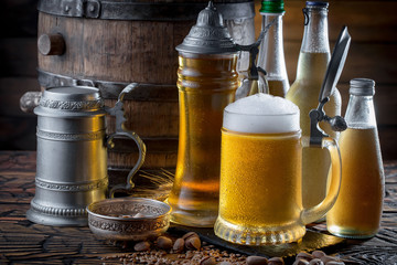 Light beer in a glass on a table in composition with accessories on an old background